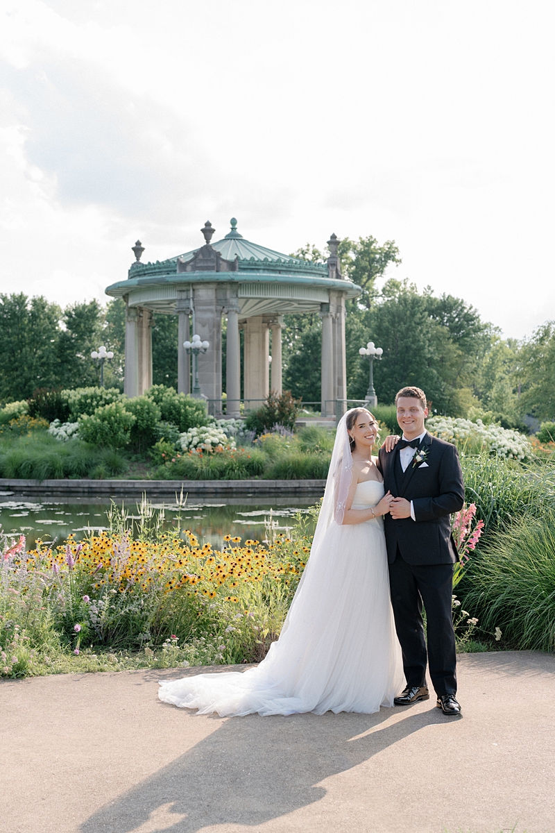 Full length wedding portrait of Jill and Dylan near The Muny in Forest Park
