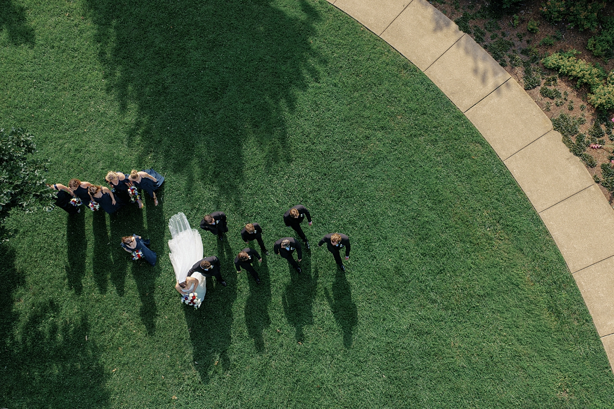 Overhead drone photograph of Jill Dylan and their wedding party in Forest Park