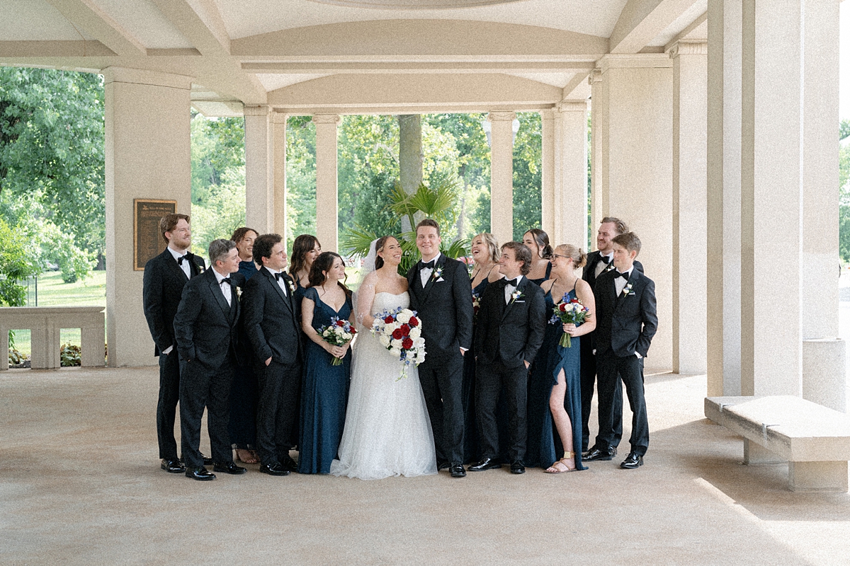 Jill and Dylan surrounded by their wedding party in Forest Park St. Louis