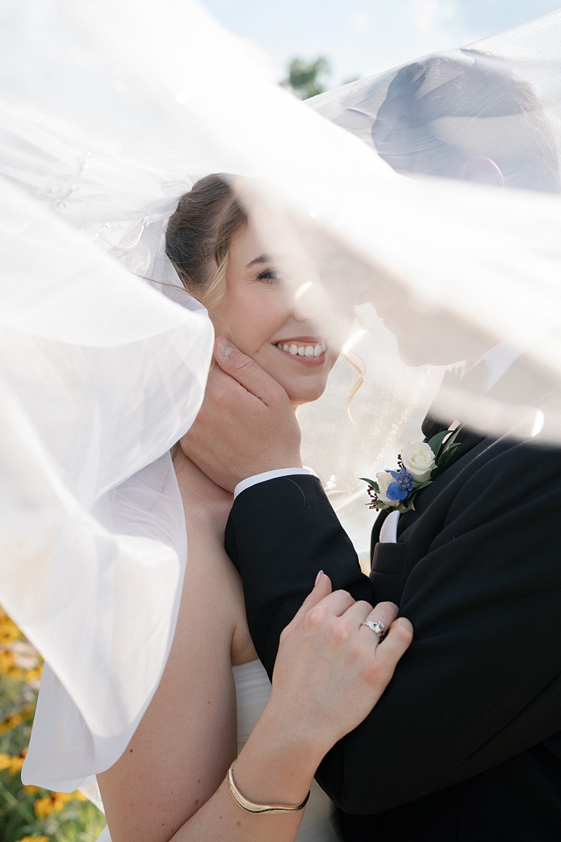 Jill smiling beneath her veil with Dylan during their Forest Park wedding portraits