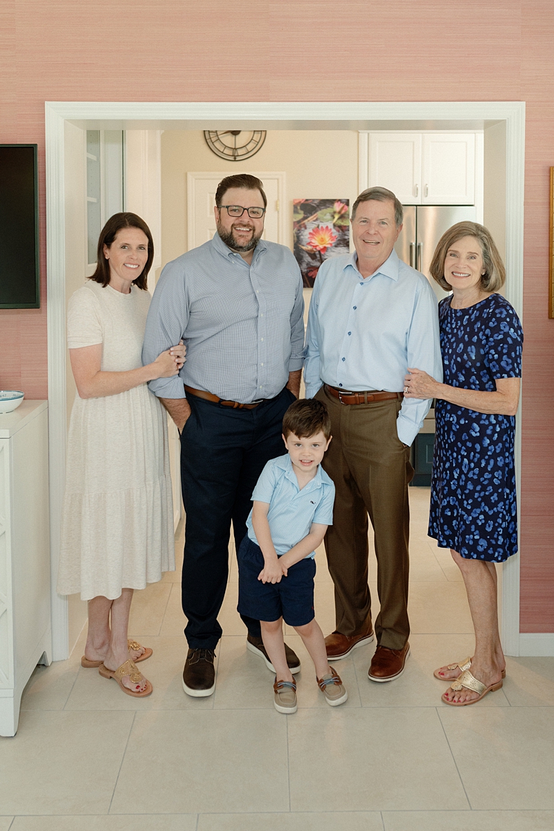 Three generations standing together inside their family home in St. Louis