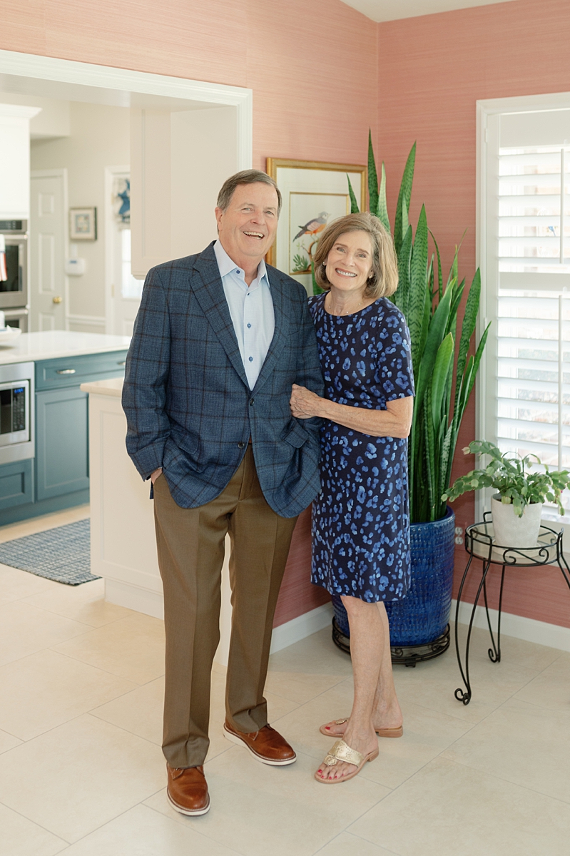 Grandparents standing together inside their St. Louis home