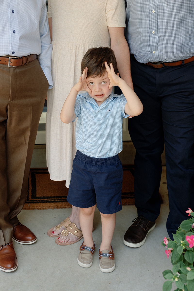 Young boy making a playful expression during extended family photos