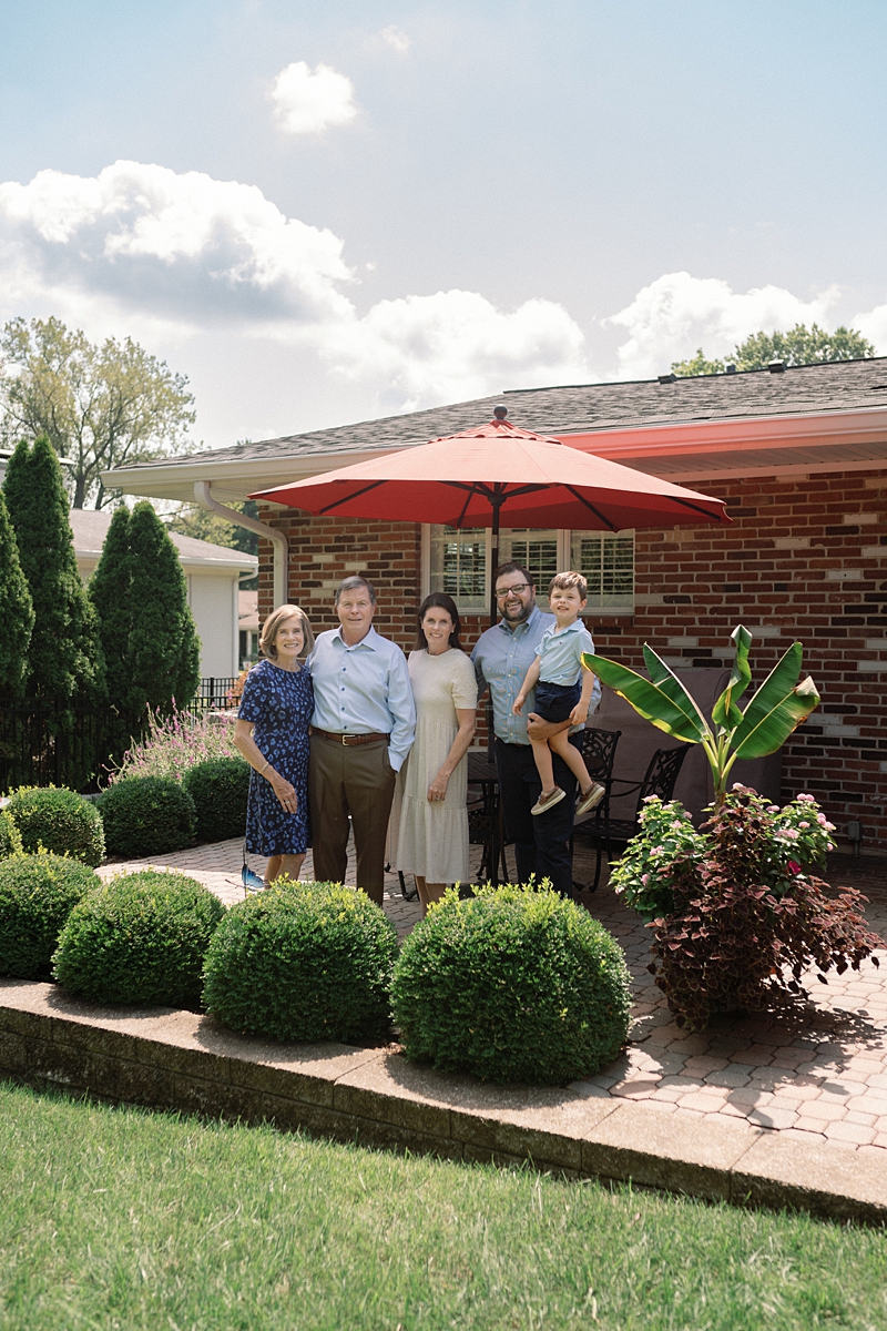 Three generations gathered in the backyard during an at-home family session