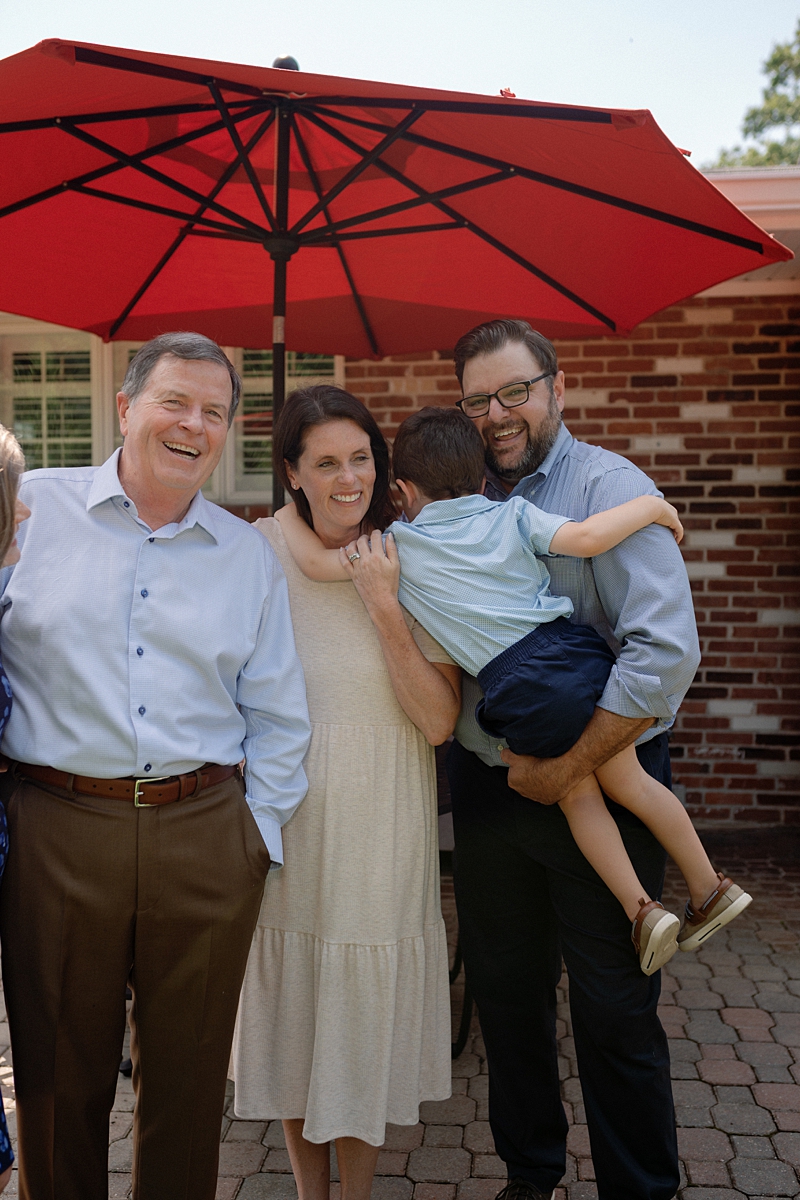 Three generations sharing a candid moment during family photos