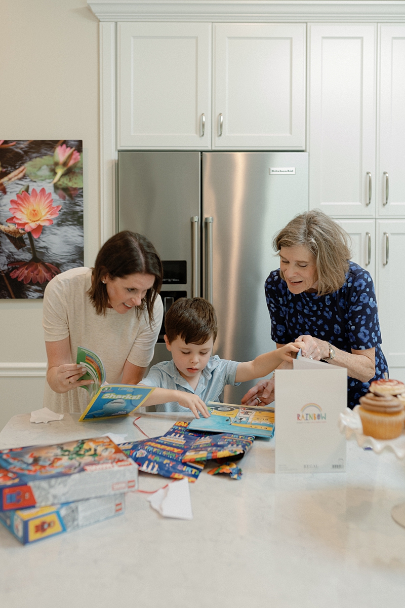 Mother grandmother and child reading together in the kitchen