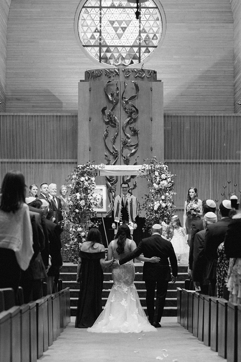 Allie walking down the aisle toward the chuppah