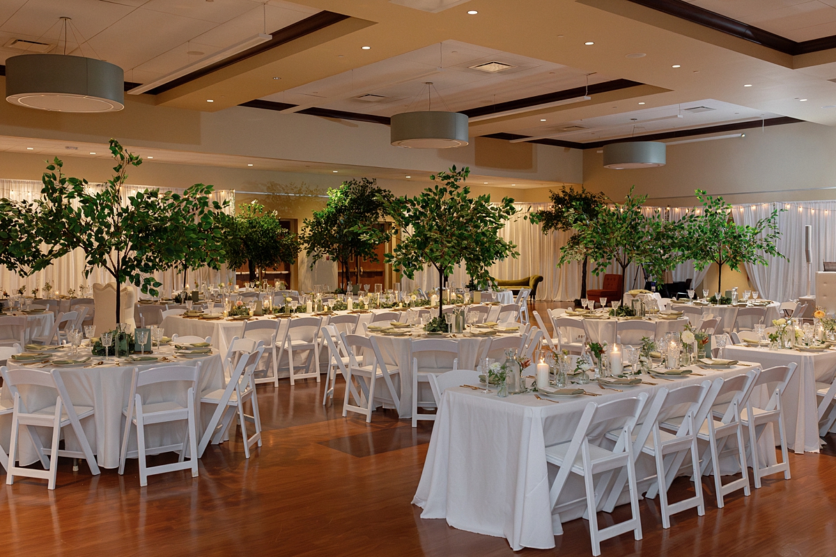 Wedding reception tables with greenery and white flowers at United Hebrew Congregation