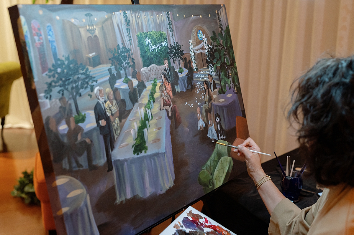 A live painter working on a scene from Allie and Nathan's wedding reception
