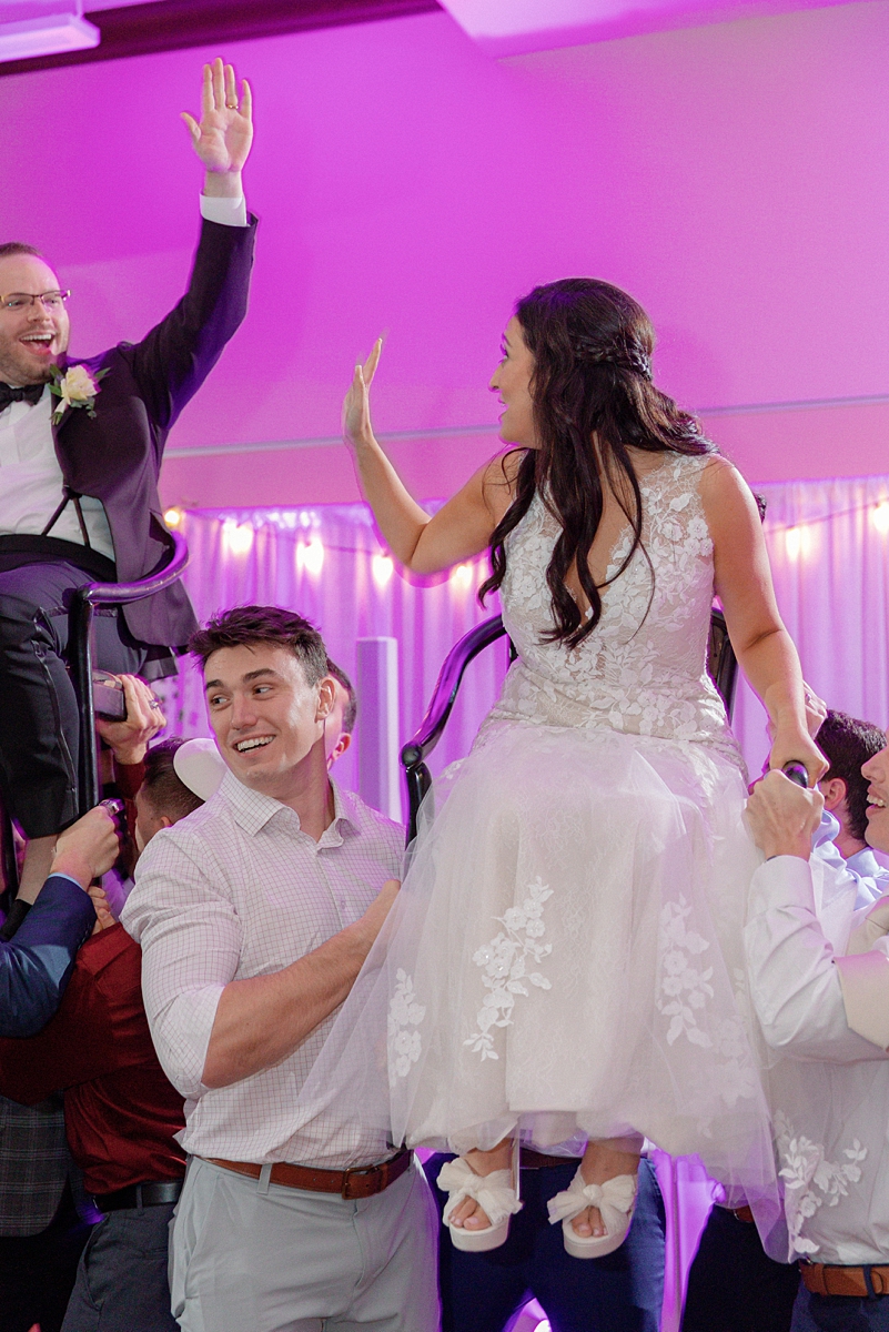 Allie lifted in a chair during the hora