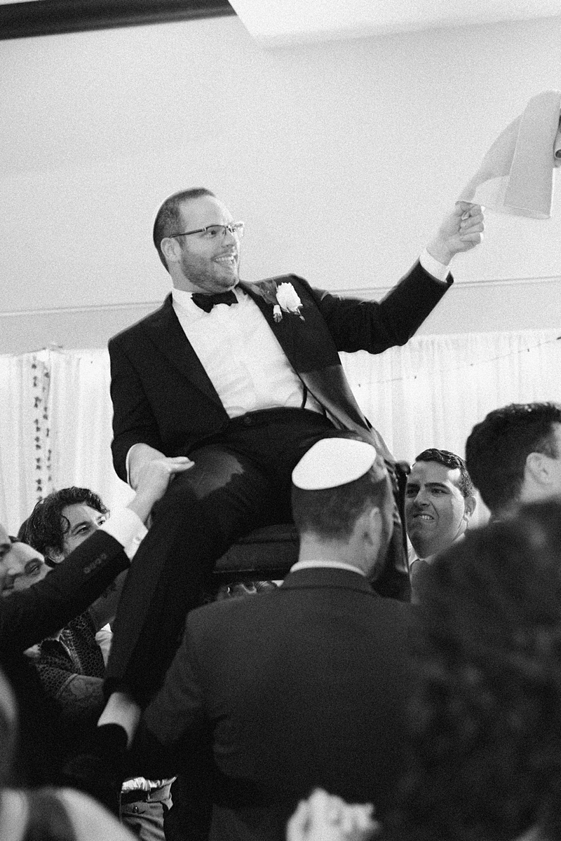 Nathan lifted in a chair during the hora