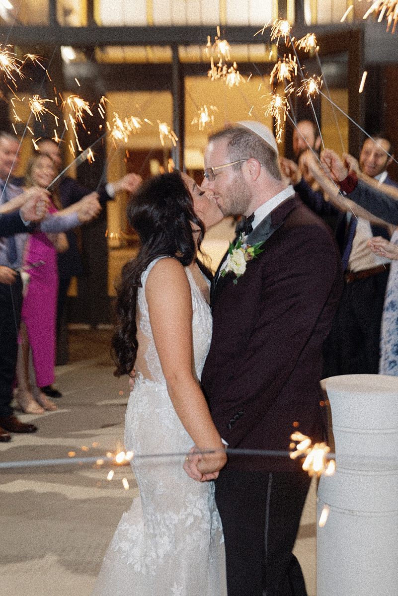 Allie and Nathan kissing during their sparkler exit