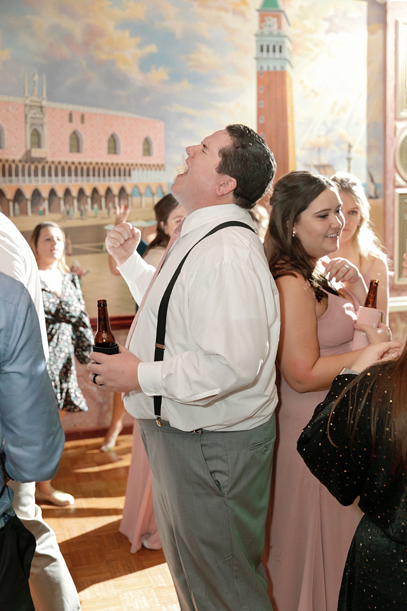 Wedding guests dancing beneath the Venetian mural at Rose of the Hill