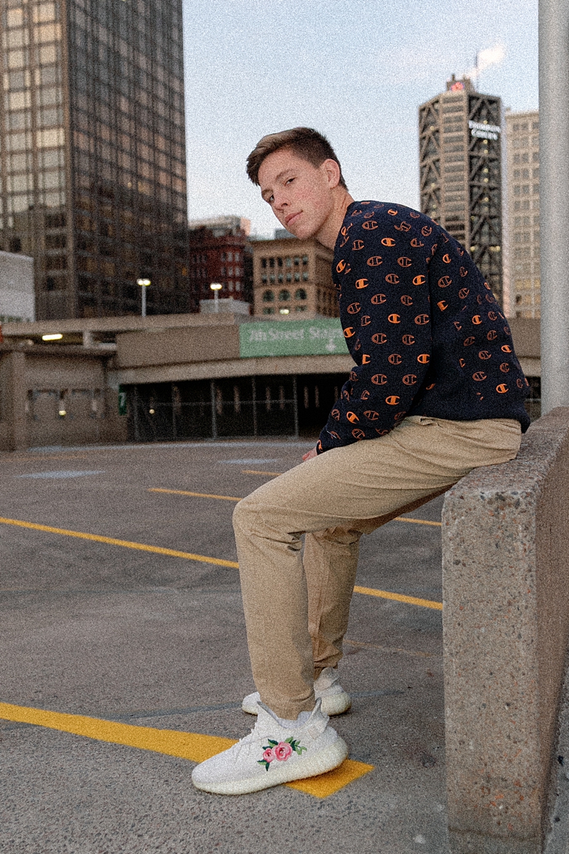 Male senior photographed on a rooftop in downtown St. Louis