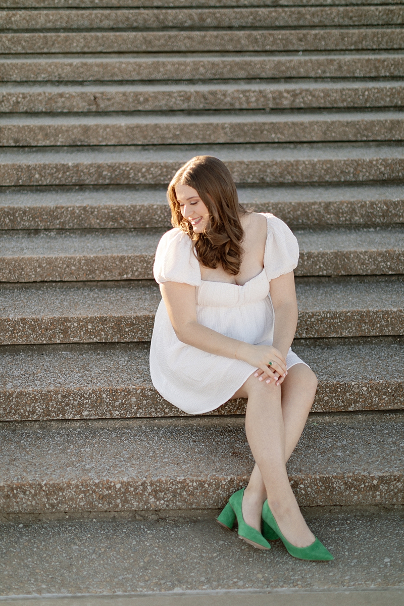 Senior wearing a white dress and green heels during a St. Louis portrait session